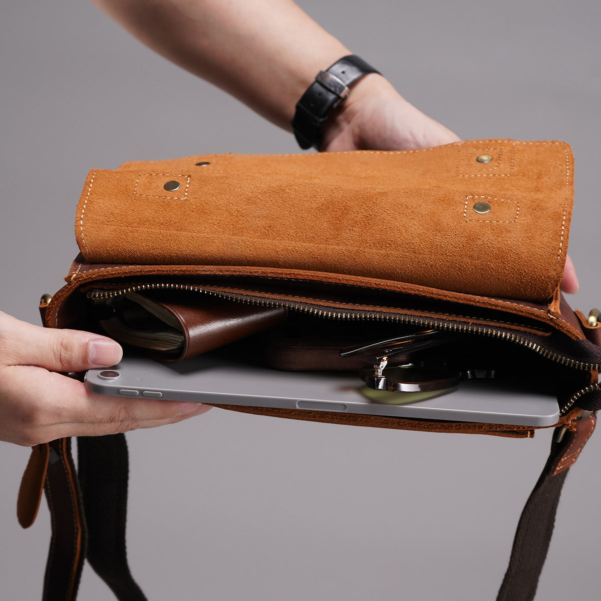 Open main compartment showing tablet-sized device and daily essentials