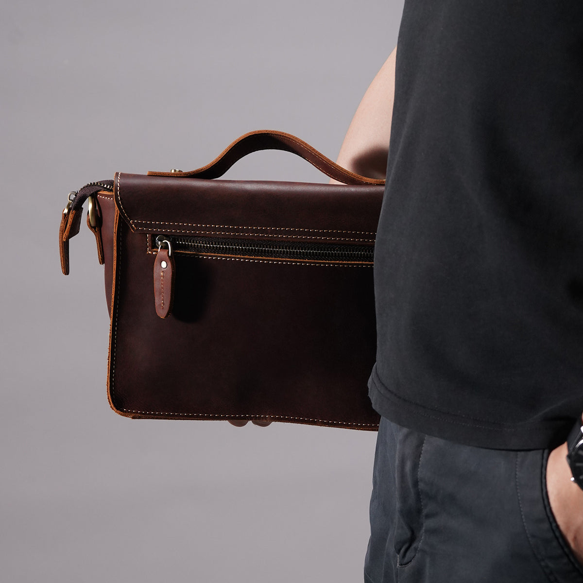 Rear profile of brown crazy-horse leather messenger satchel