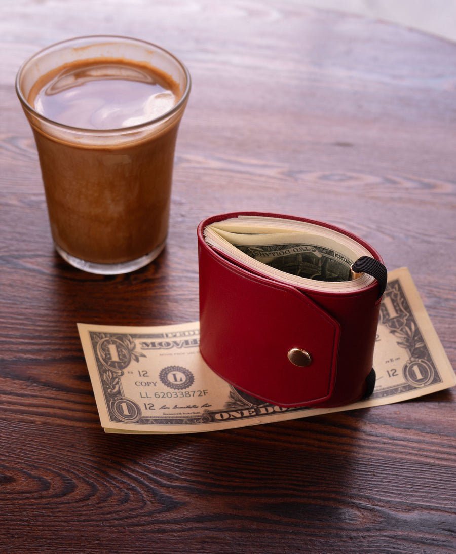 Leather cash wrap holding an everyday folded bill stack