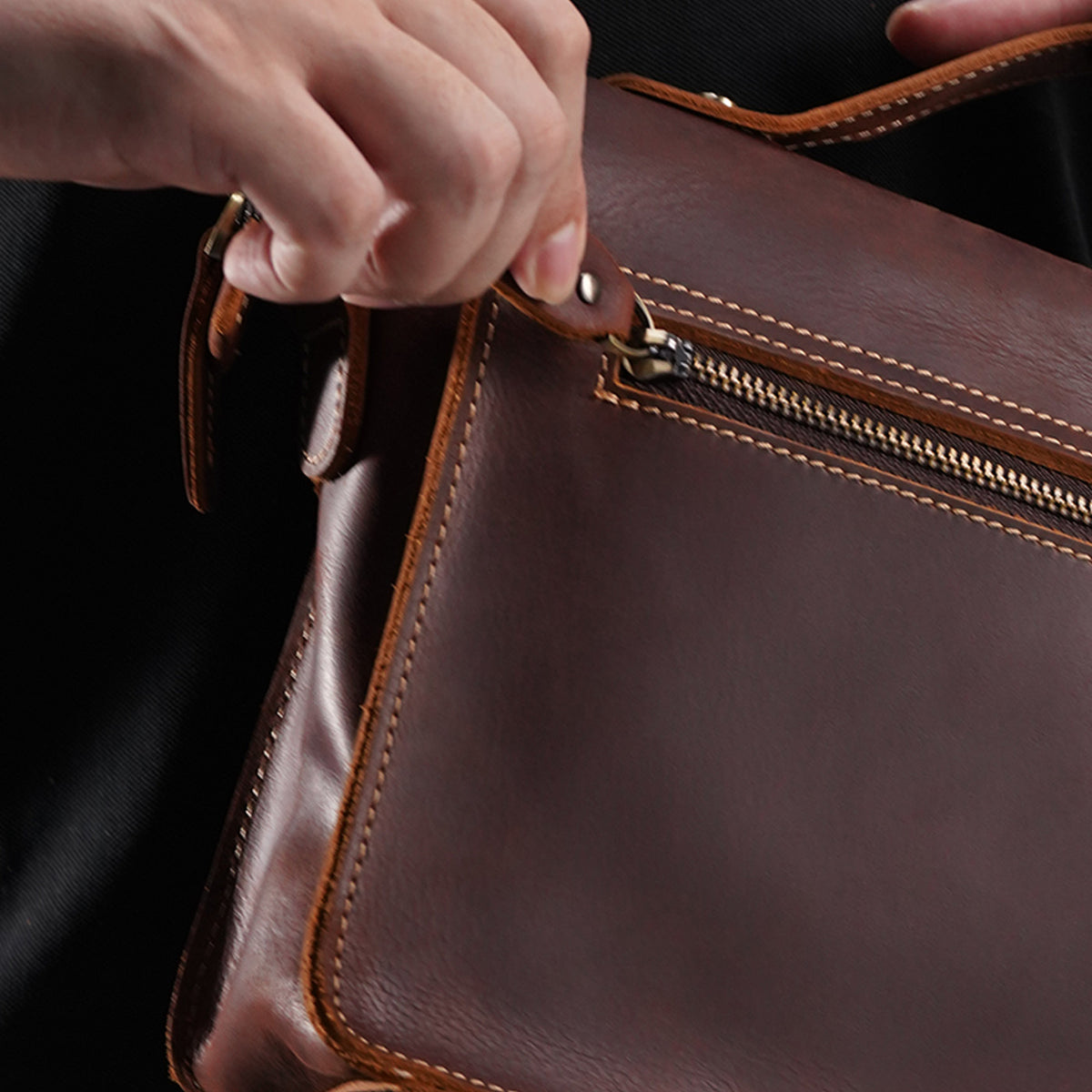 Close view of crazy-horse leather grain, stitching and zipper hardware