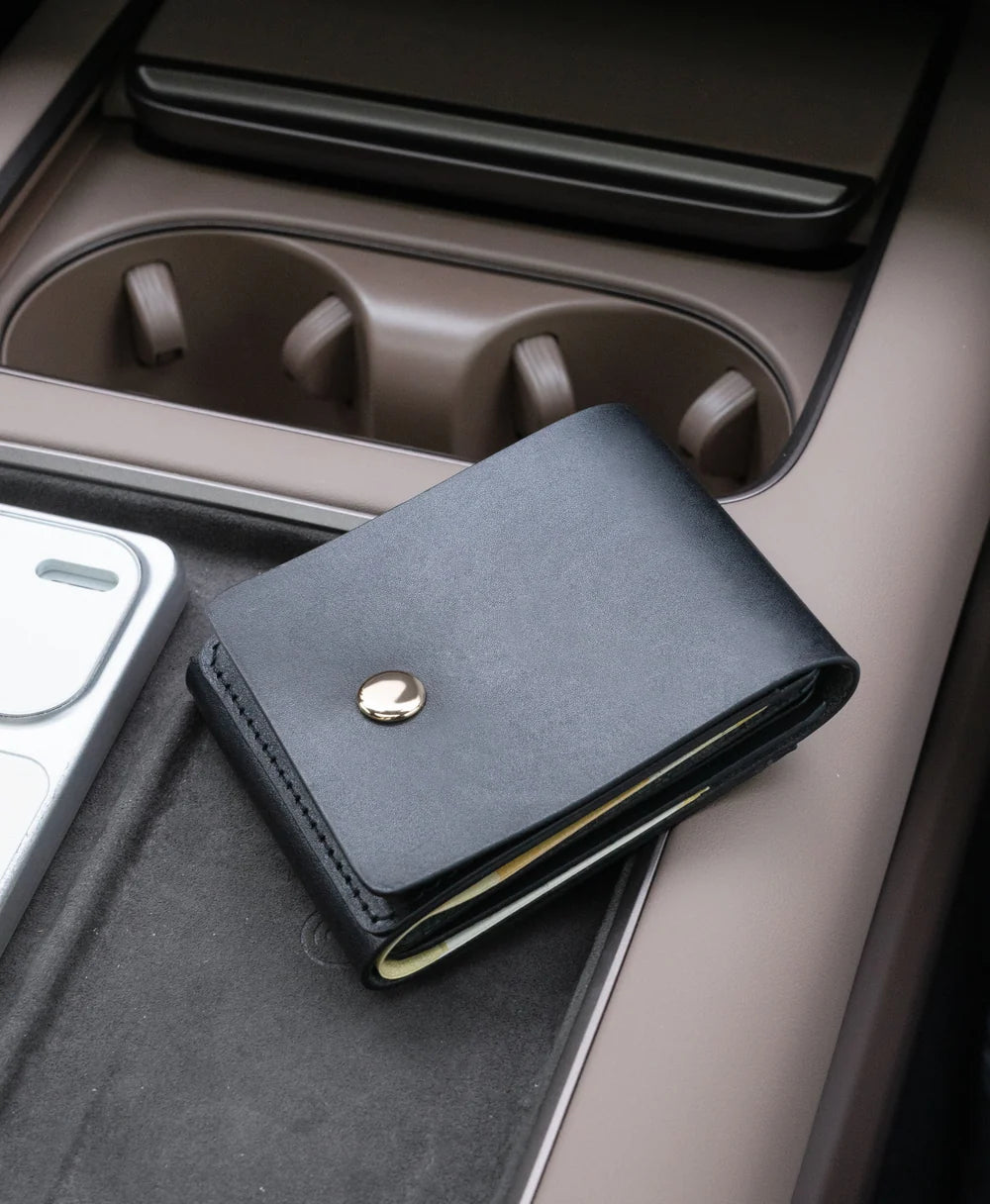 Black saddle leather vertical wallet lifestyle detail