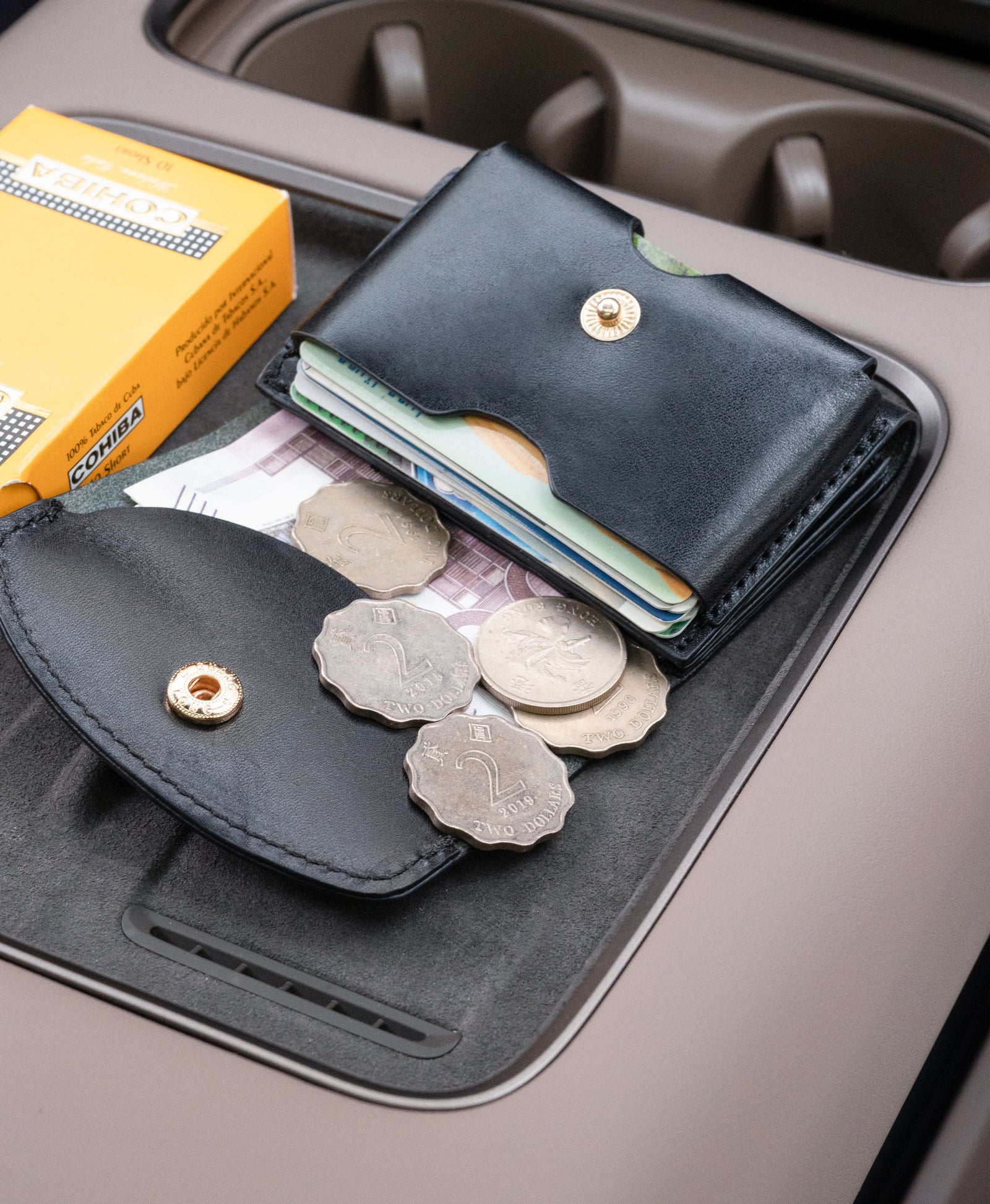 Black saddle leather trifold wallet lifestyle detail
