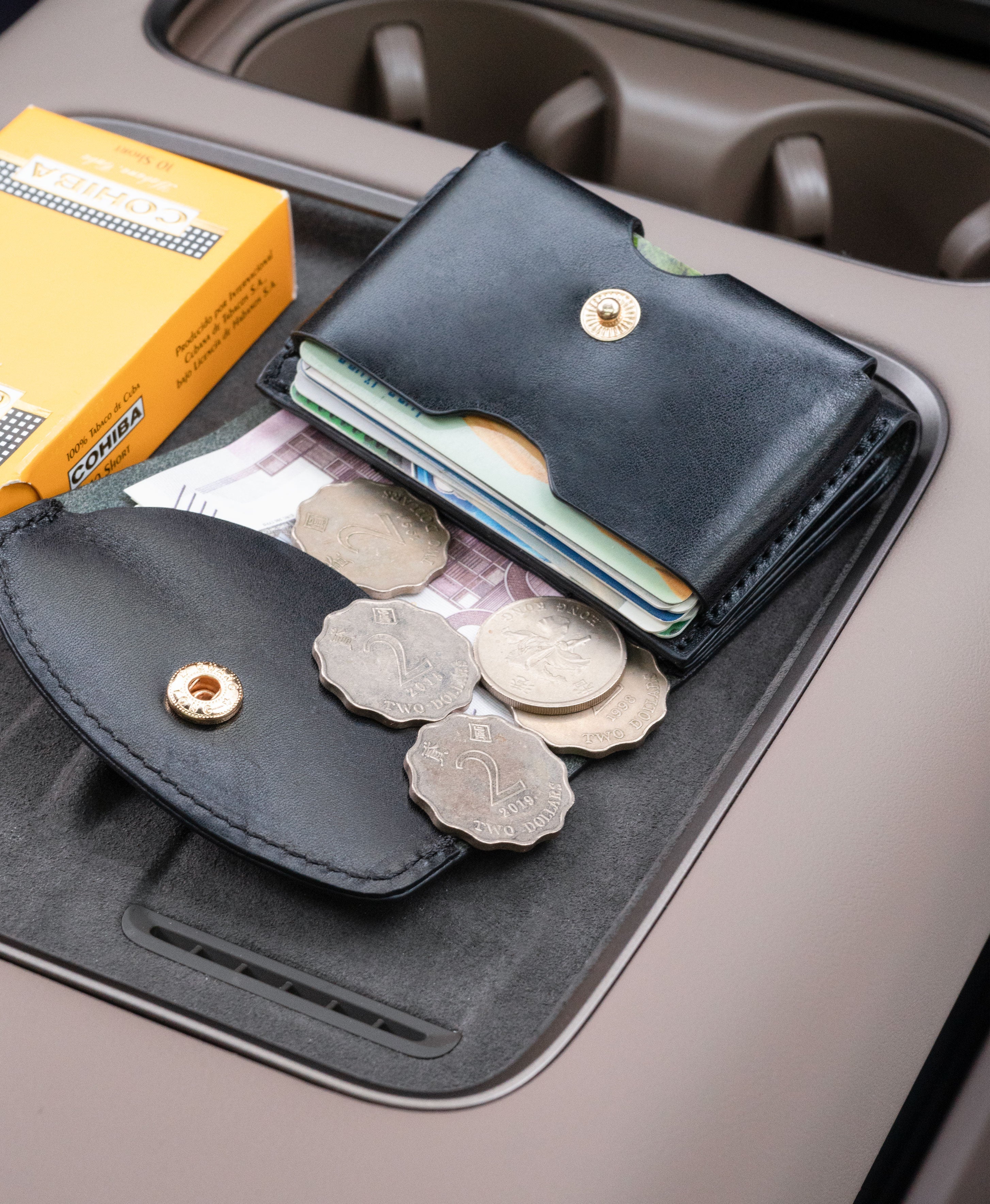 Black saddle leather trifold wallet lifestyle detail