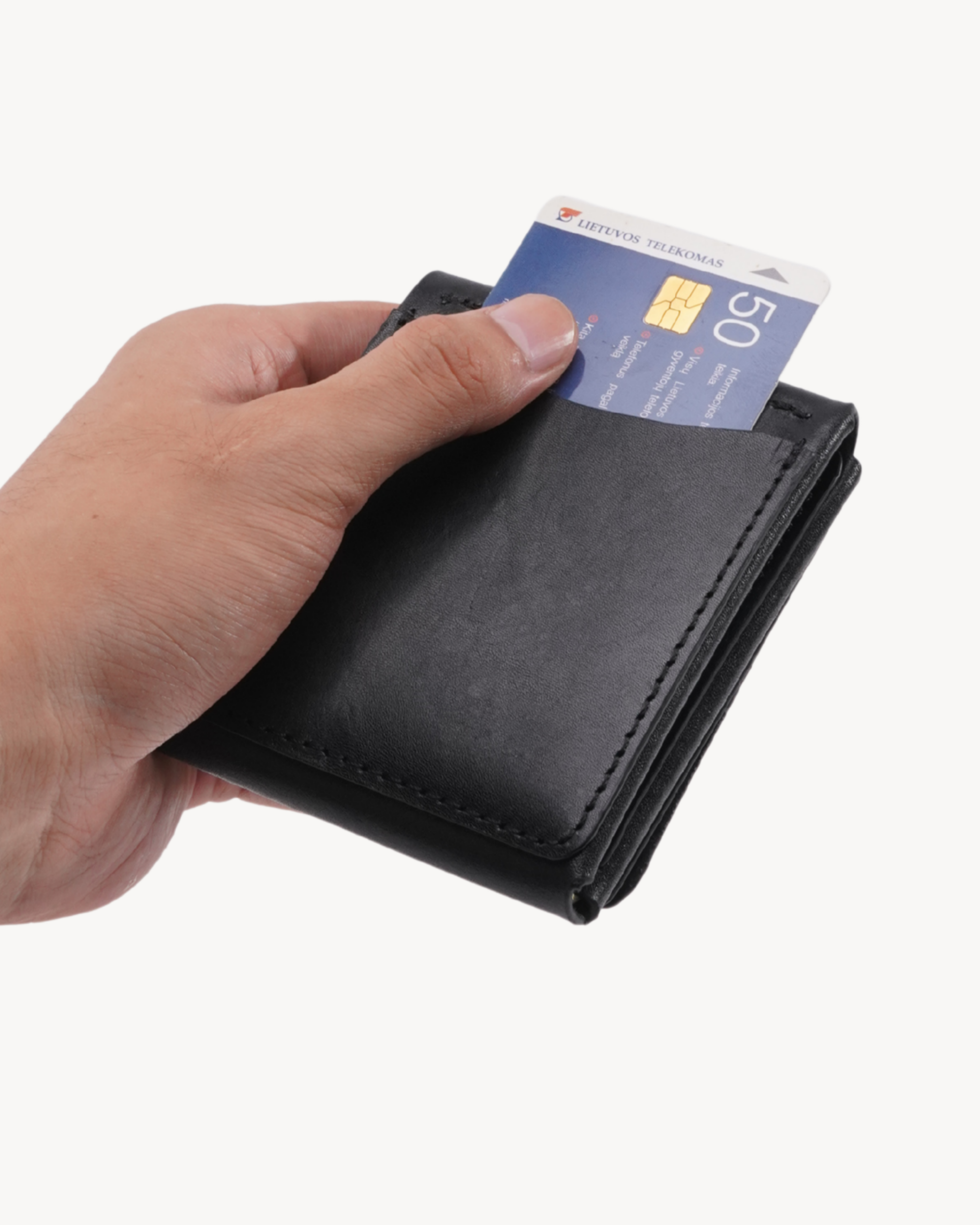 Handmade Full-Grain Saddle Leather Vertical Snap Wallet - exterior quick-access pocket in hand