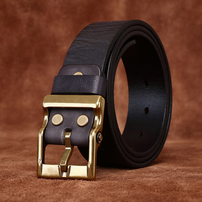 Black leather belt detail with antique brass-tone pin buckle