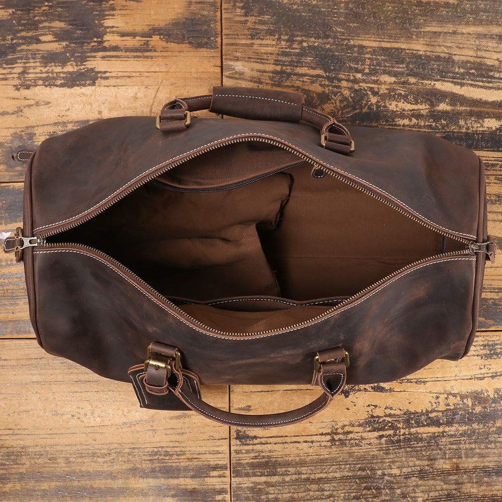 Wide zip opening and unfilled interior of the leather travel duffle