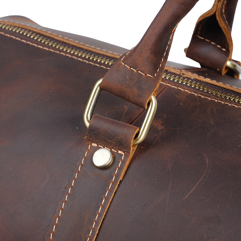 Riveted leather handle reinforcement and antique-tone hardware