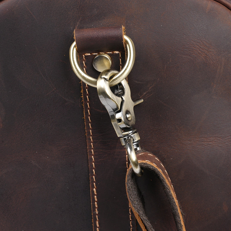 Detachable metal shoulder strap clip and reinforced leather tab