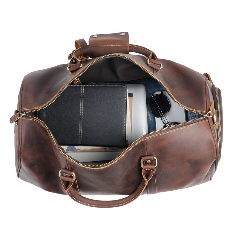 Leather travel duffle opened to show its 31.25 litre packing capacity