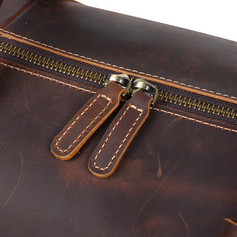 Twin metal zipper pulls with leather tabs