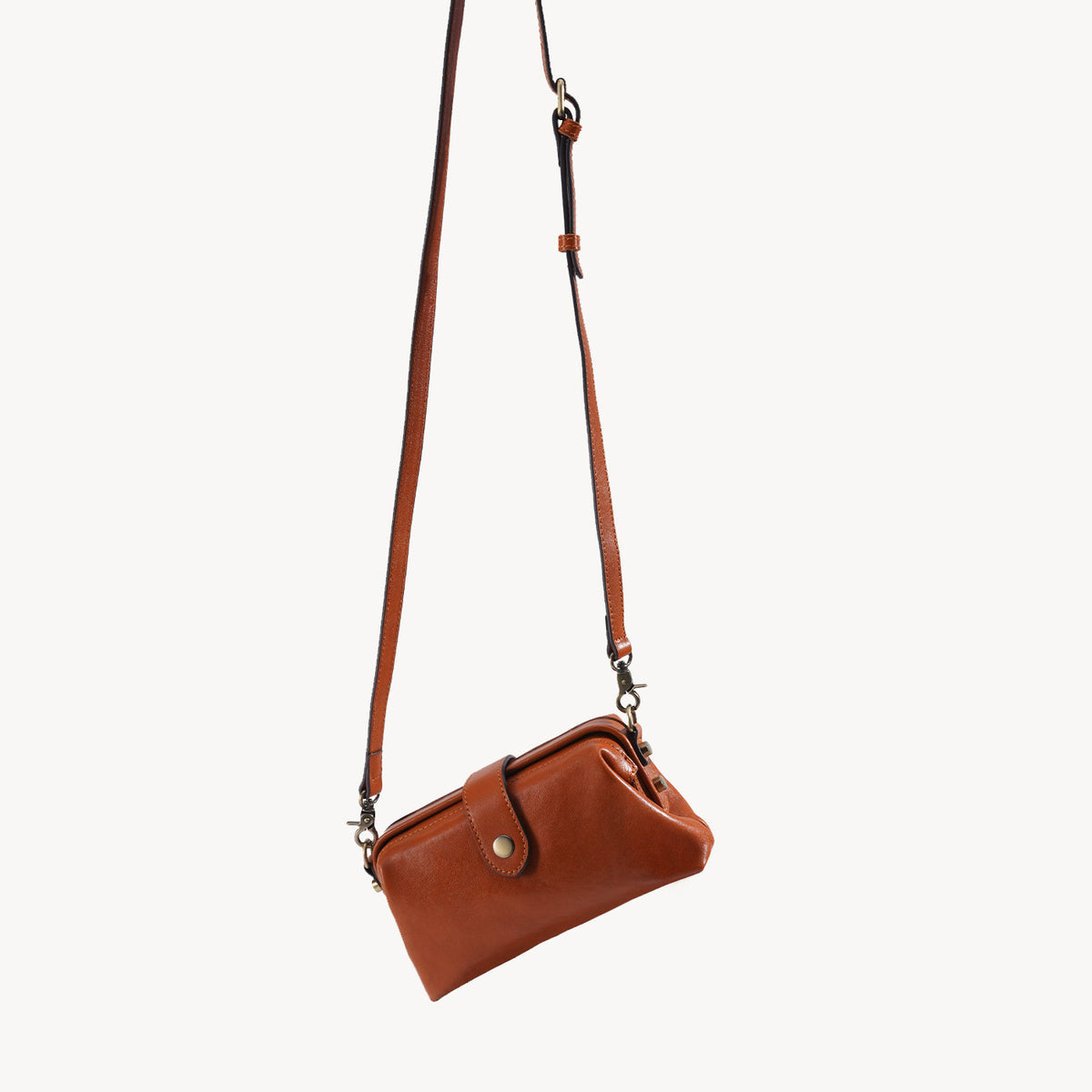 Back profile of the vintage brown leather frame crossbody bag