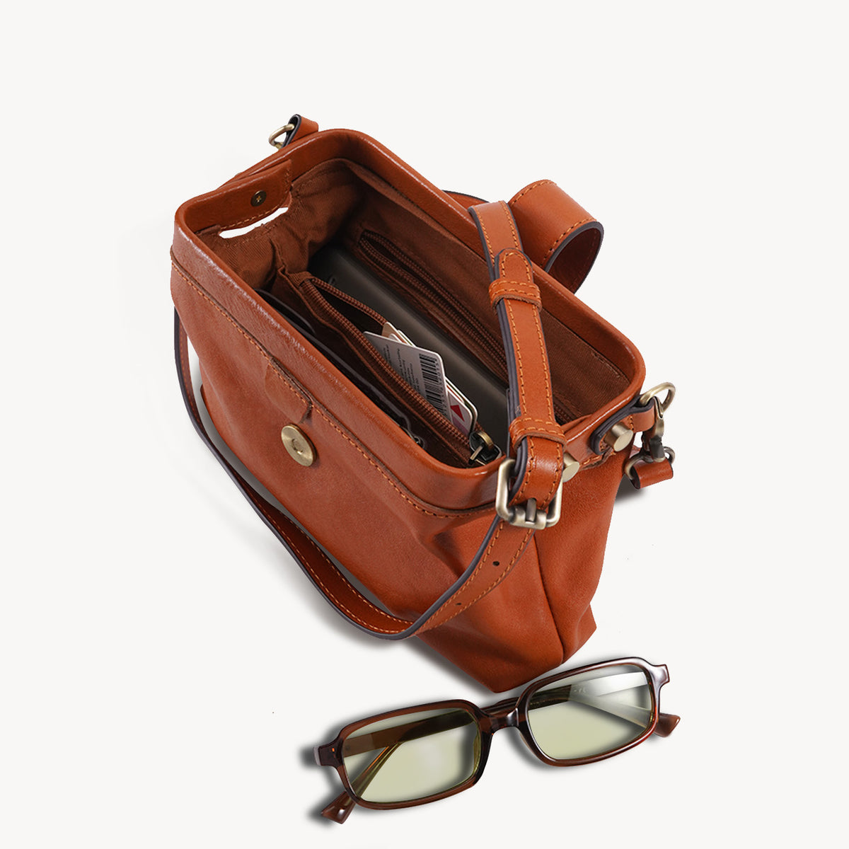 Leather frame crossbody bag opened to show the main compartment