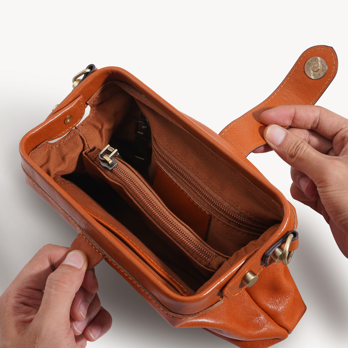 Wide frame opening and lined interior of the compact crossbody bag