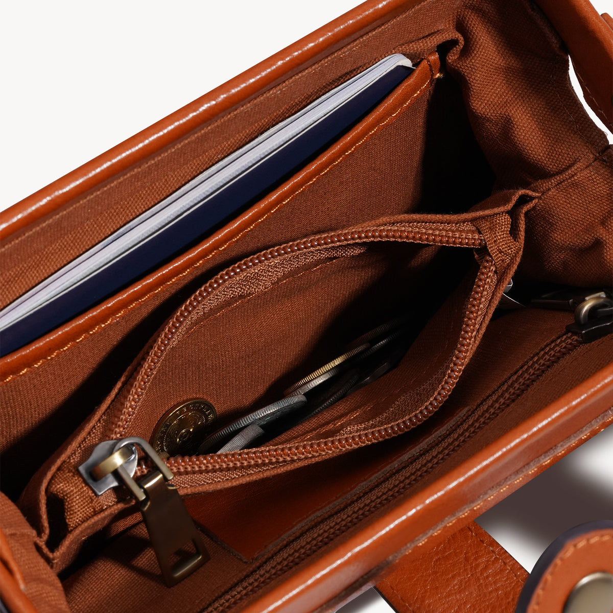 Interior zip pocket inside the vegetable-tanned leather crossbody bag