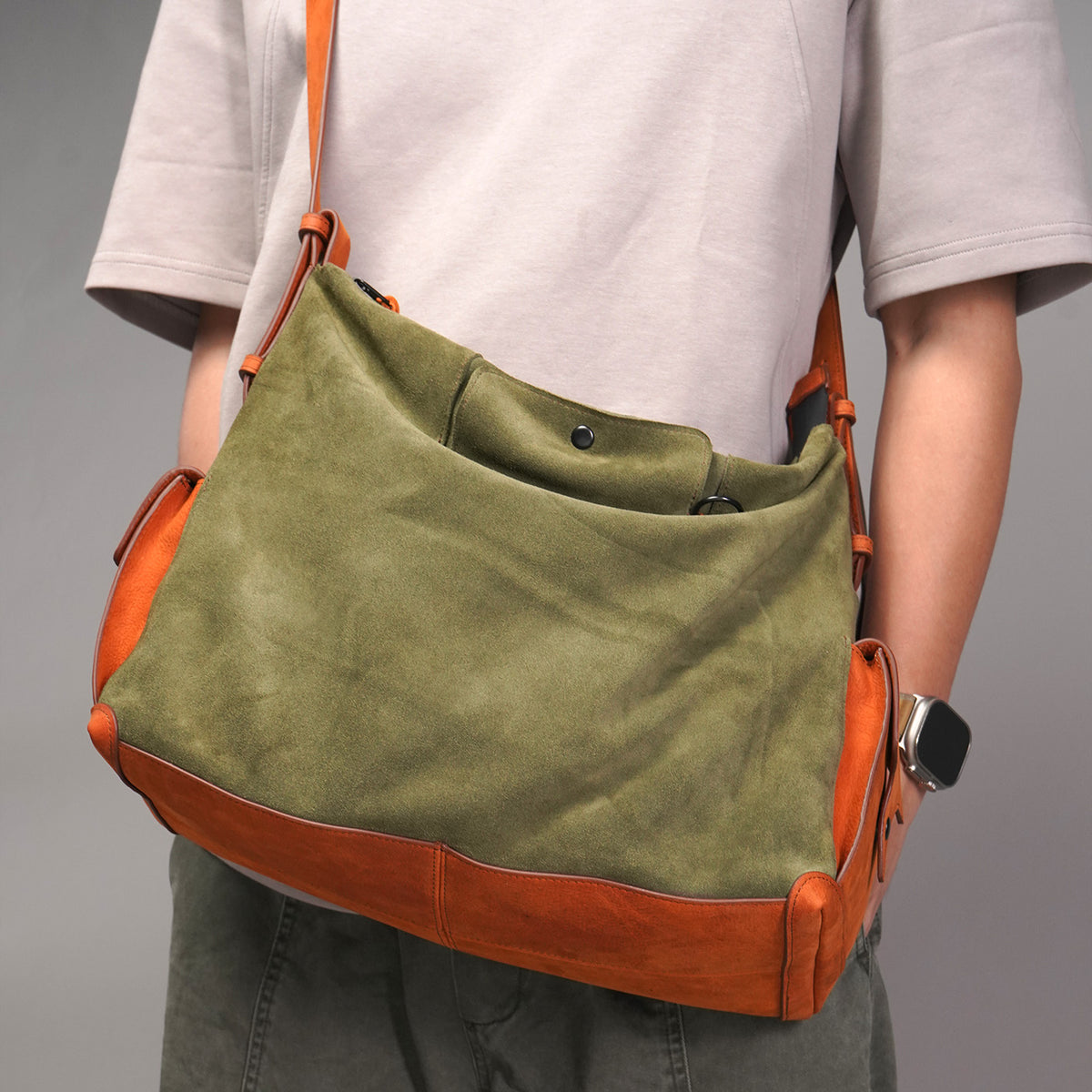 KAKAVY Roam suede and leather bag shown worn at the hip