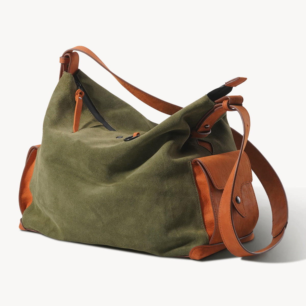 Side view of the KAKAVY Roam bag showing leather base trim and shoulder strap