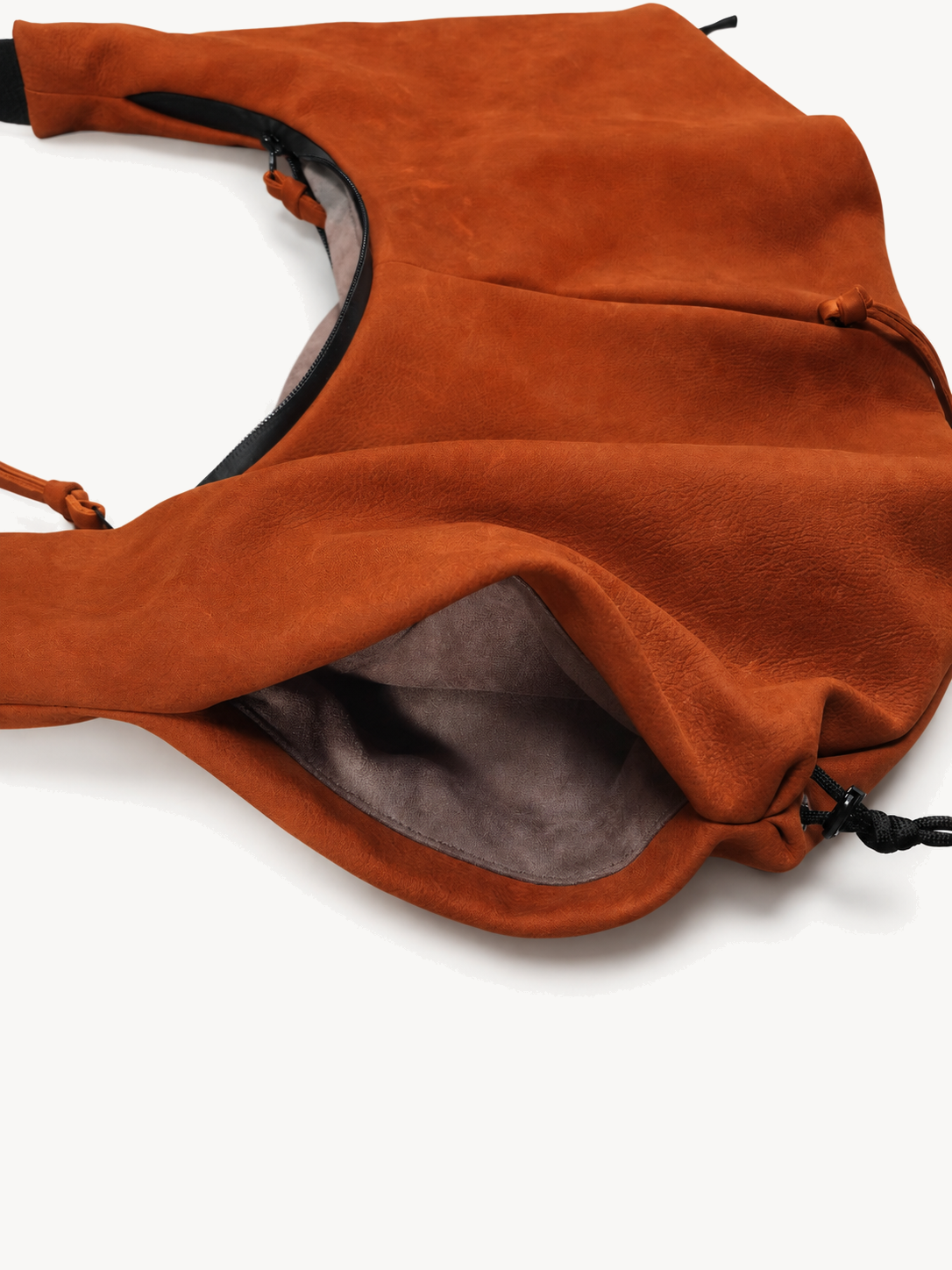 Open drawcord end pocket on the orange cowhide utility crossbody bag