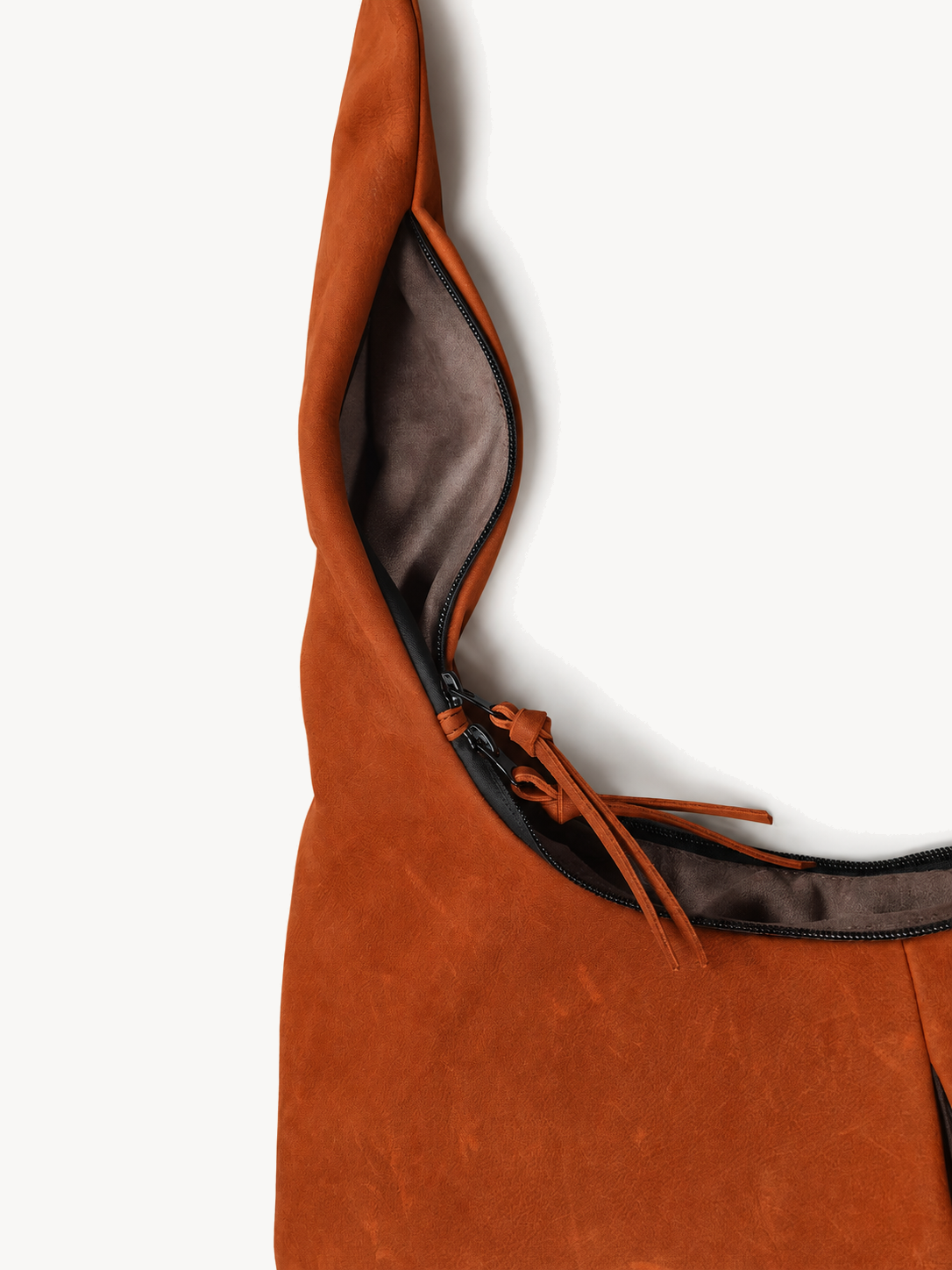 Close view of the wide opening and soft lining of the orange cowhide crossbody bag