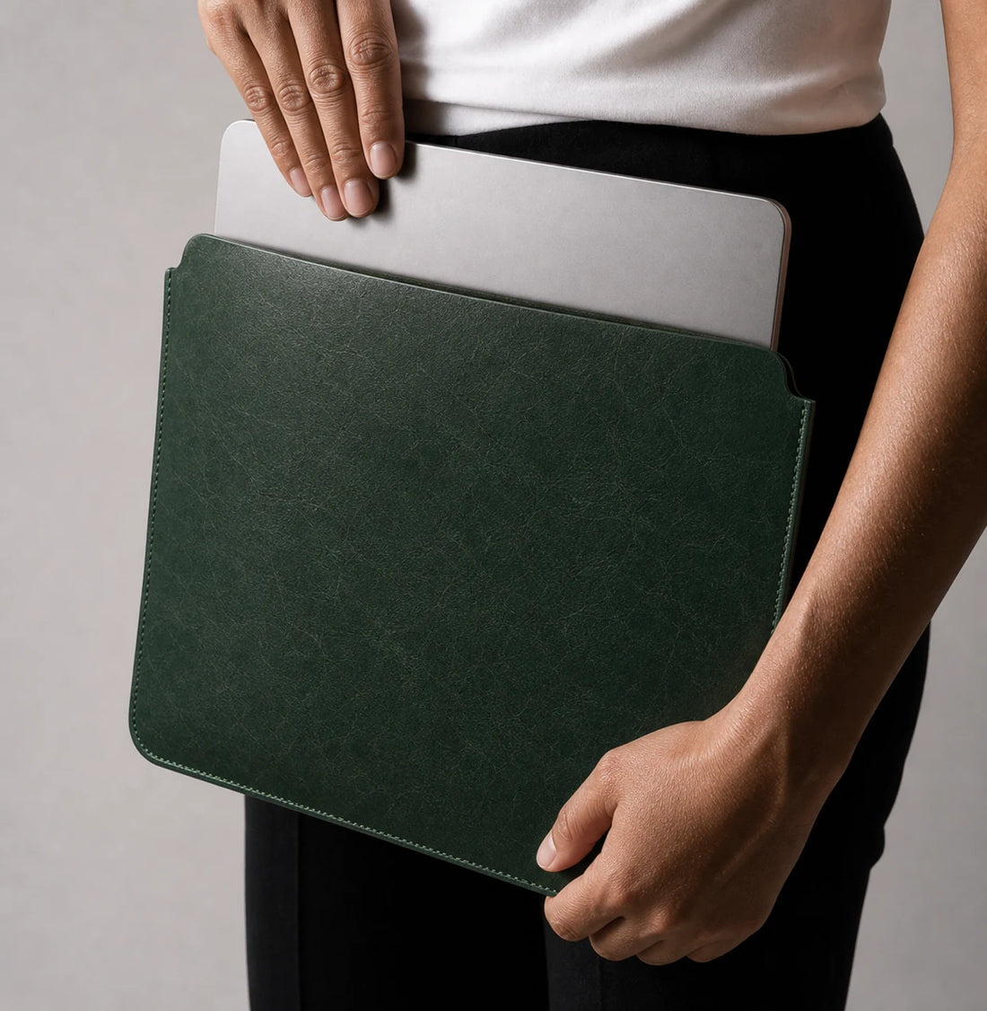 Tablet sliding into forest green leather iPad and MacBook sleeve