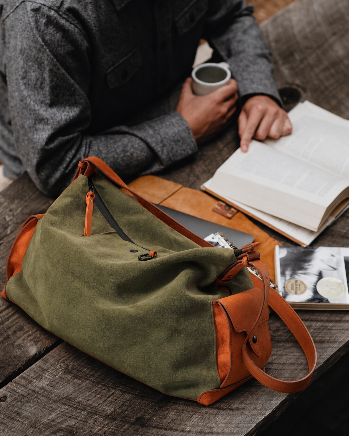 KAKAVY - Olive Green Leather Pocket Crossbody Bag - On a wooden table
